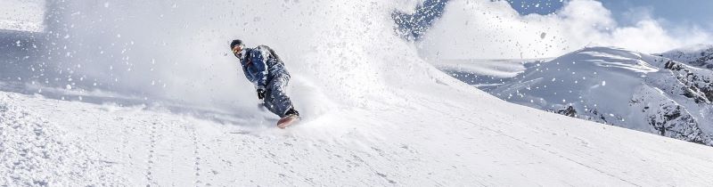 A man riding a snowboard that was purchased with financing.