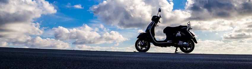 A moped parked on the street after the owner got financing.